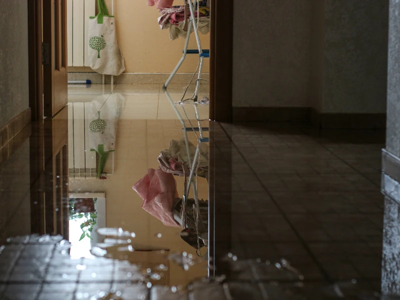 Professional flood clean up crew extracting water from a slab-on-grade home interior in a Mandeville LA subdivision following a heavy rainfall flooding event