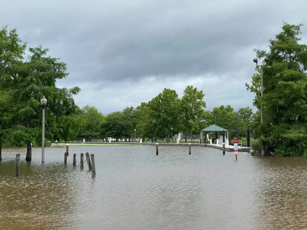 Flooded canal-adjacent residential neighborhood in Slidell LA requiring immediate emergency water restoration response following a storm surge event on Lake Pontchartrain