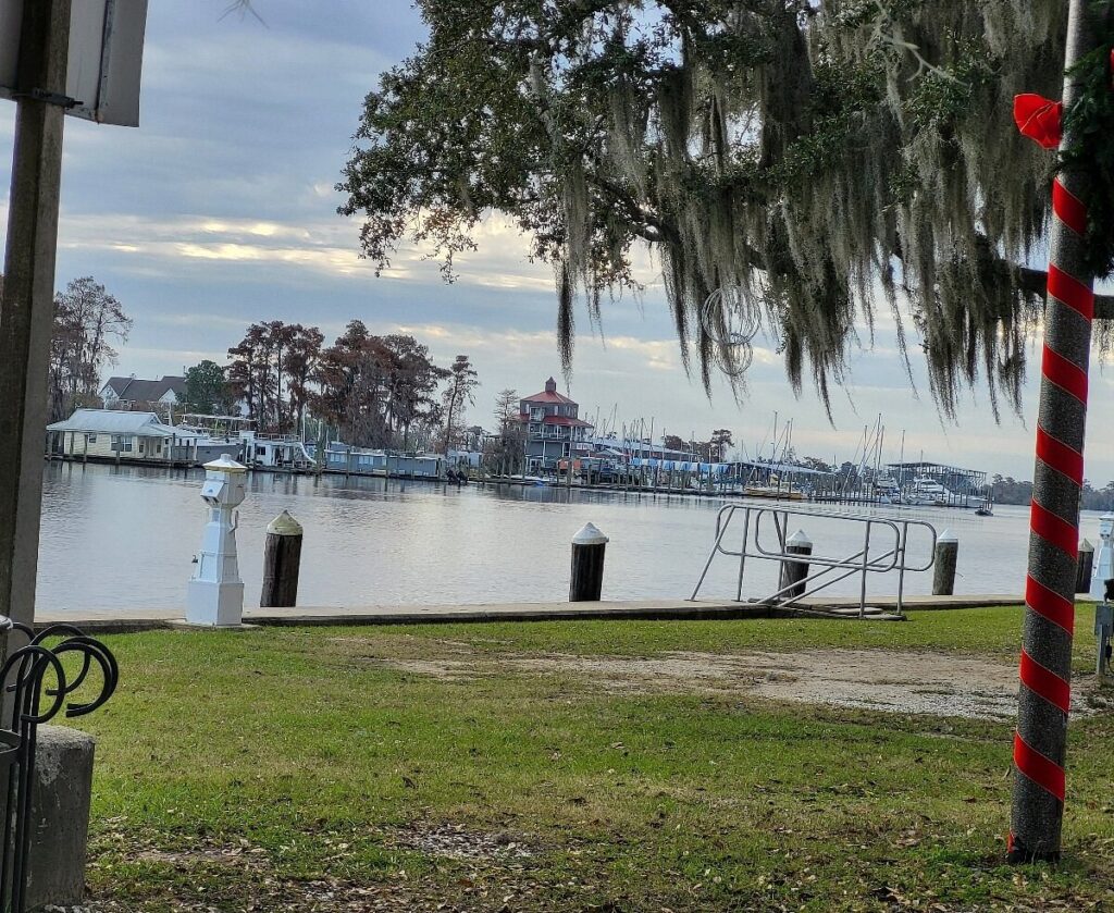 Waterfront marina and boatyard property in Madisonville LA along the Tchefuncte River showing water damage restoration needs for marine industry and residential waterfront properties