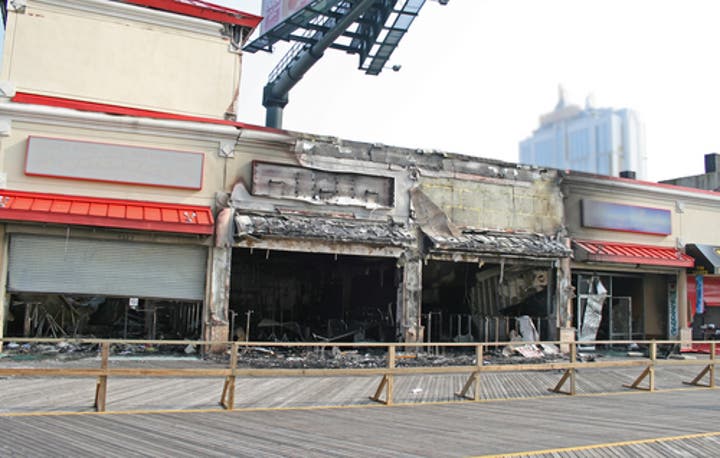 Emergency fire restoration team assessing smoke and fire damage inside a commercial restaurant property