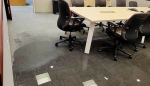 Office with water-damaged floors (carpet tiles)