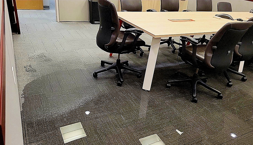 Office with water-damaged floors (carpet tiles)