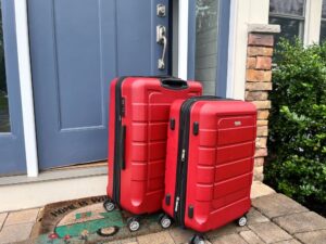 Two suitcases packed for vacation and outside the front door