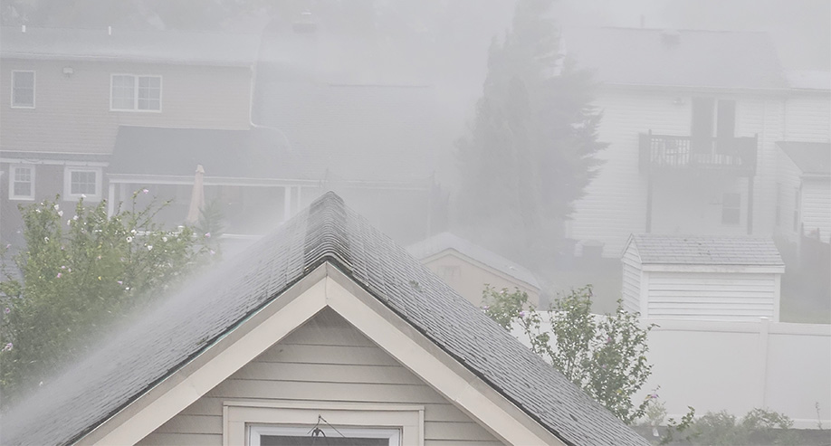 Heavy rain over rooftops, a flood in the making