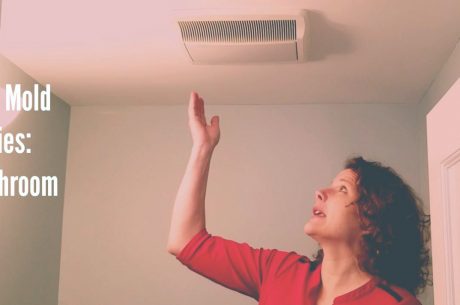 woman gesturing at bathroom exhaust fan