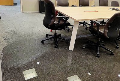 Office with water-damaged floors (carpet tiles)