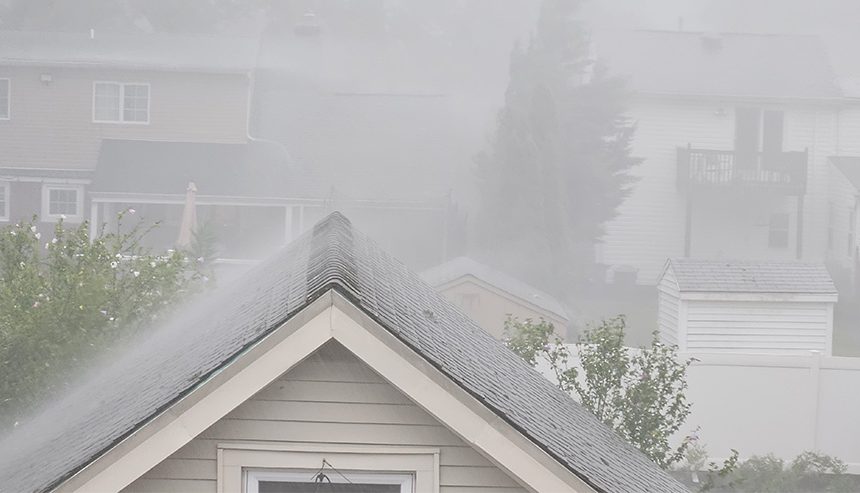 Heavy rain over rooftops, a flood in the making