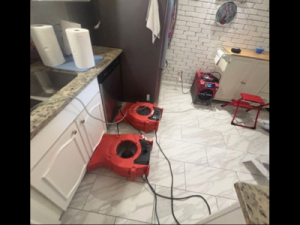 Drying equipment in place as part of a home water damage restoration process, helping remove excess moisture and support proper drying inside a residential space.