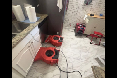 Drying equipment in place as part of a home water damage restoration process, helping remove excess moisture and support proper drying inside a residential space.
