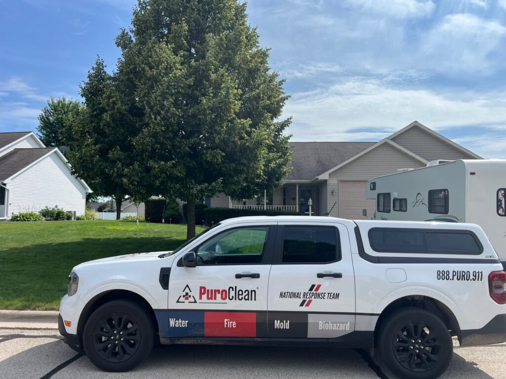 PuroClean National Response Team vehicle parked in front of a residential property, ready to assist with business property water restoration services.