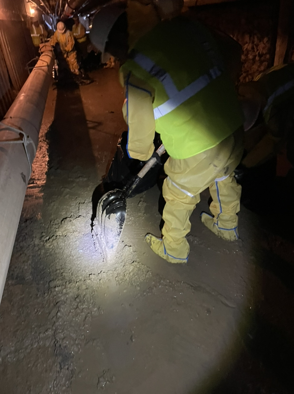 shoveling muck in pool drain