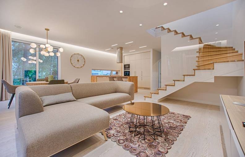 Bright, modern open-concept living space with a sectional sofa, kitchen, and floating staircase

top trauma scene cleanup in Davenport