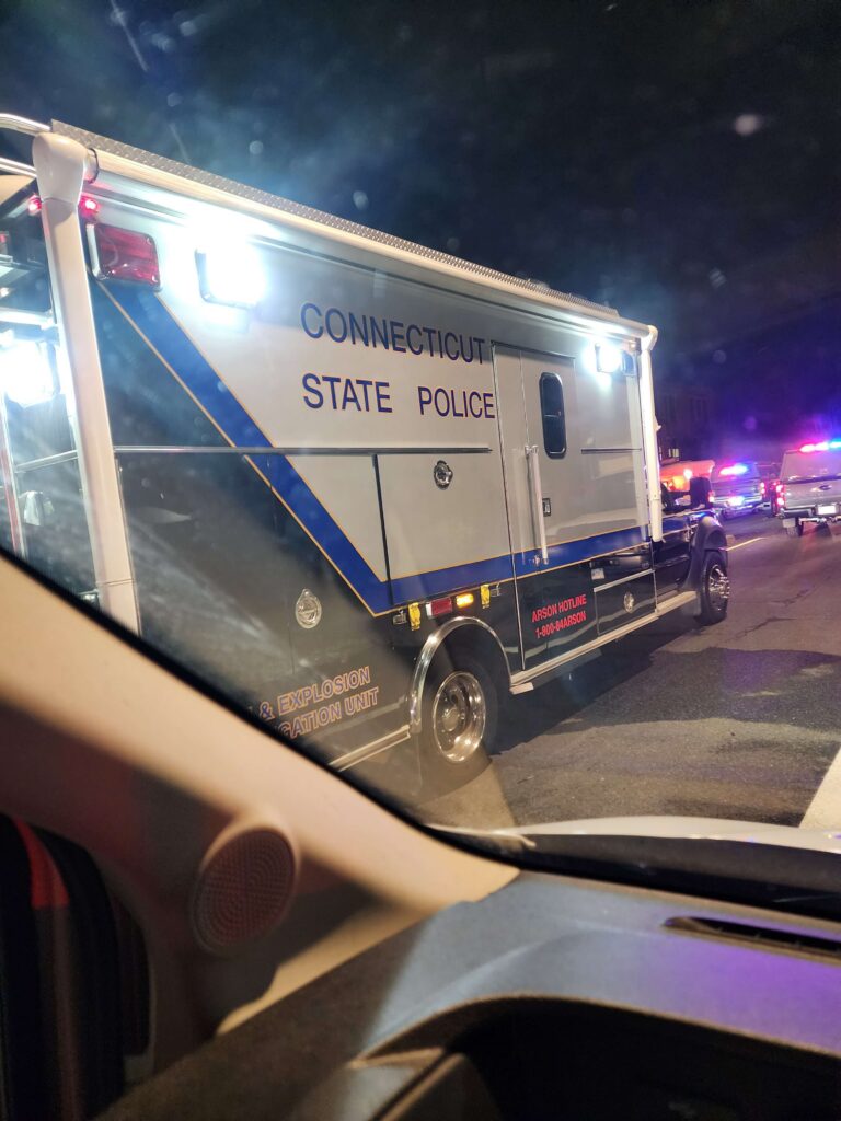 Connecticut State Police Arson & Explosion Investigation Unit truck with flashing emergency lights at night.