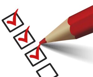 A red pencil checks three boxes on a checklist, leaving one empty.