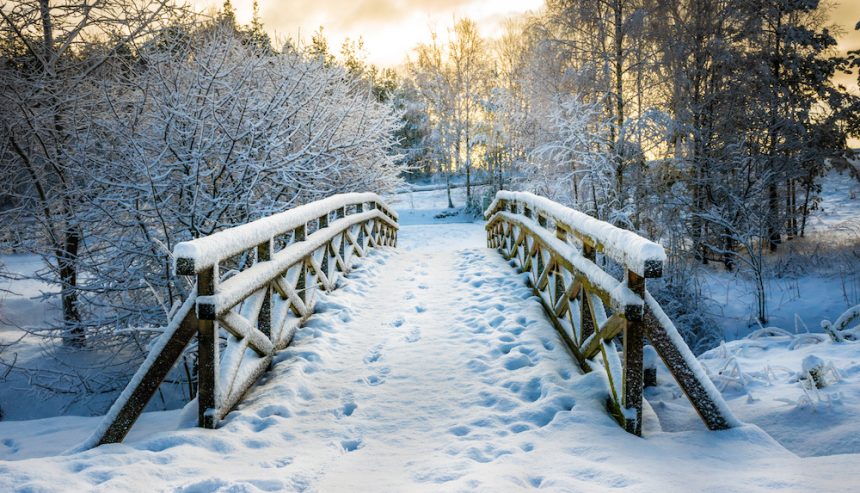 Snowy, wooden bridge in a winter day. Winter safety tips.