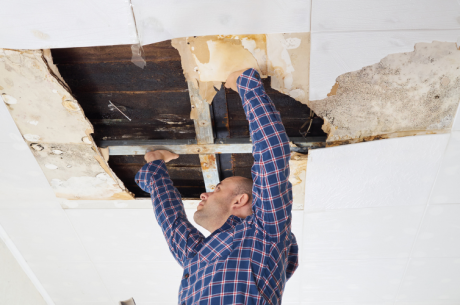 man-fixing-water-damamged-ceiling
