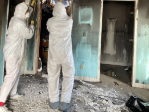 PuroClean team restoring a fire-damaged home in Green Bay, removing debris and repairing structural damage.