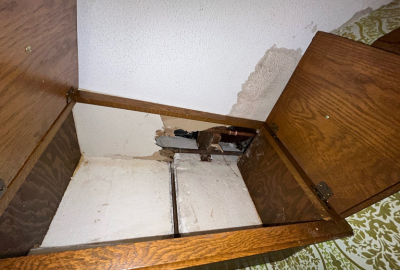 Water damage behind kitchen cabinetry with visible ceiling stains and structural deterioration, requiring reconstruction by PuroClean of Green Bay.