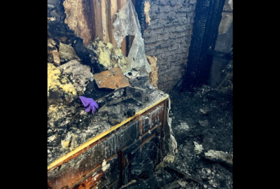 Severe fire and smoke damage to interior walls, insulation, and cabinets with charred debris, showing the need for professional smoke damage restoration.