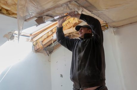 A worker with a restoration company helps mitigate damage in a building