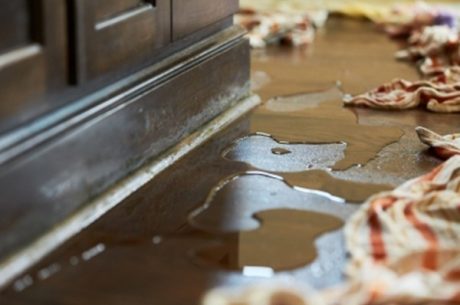 water damage repair technicians repairing damaged drywall and flooring inside home Hapeville Georgia