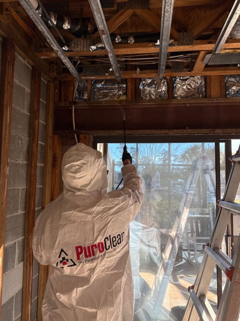 PuroClean worker in a hazmat suit