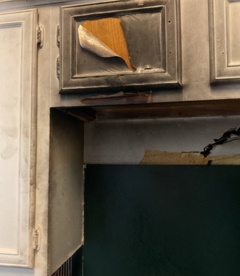 Fire and smoke damage on her cabinets.