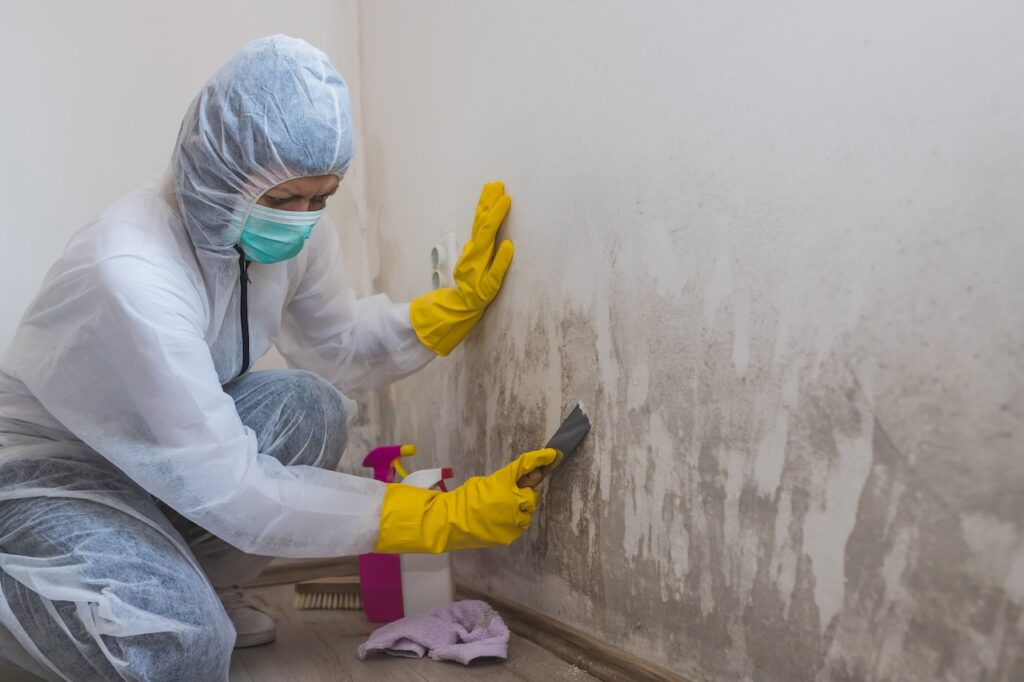 Worker cleans mold.
