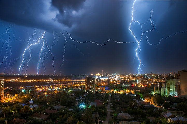 Severe lightning behind a house during summer storms.