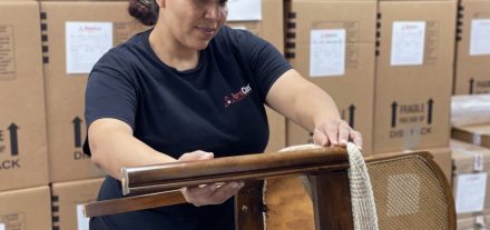 Woman restoring a chair during the pack-out process