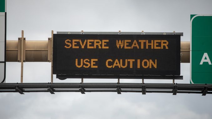 Use caution sign on highway in long island. Springtime rain