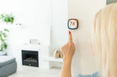 High humidity is a silent killer in your home. woman check thermostat