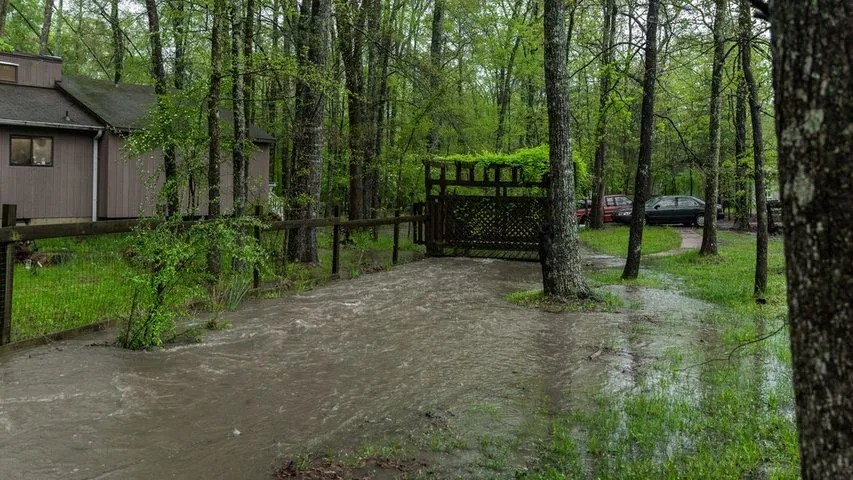A yard flooded outside of a long island home. 8 ways to prevent your yard from flooding this spring and summer