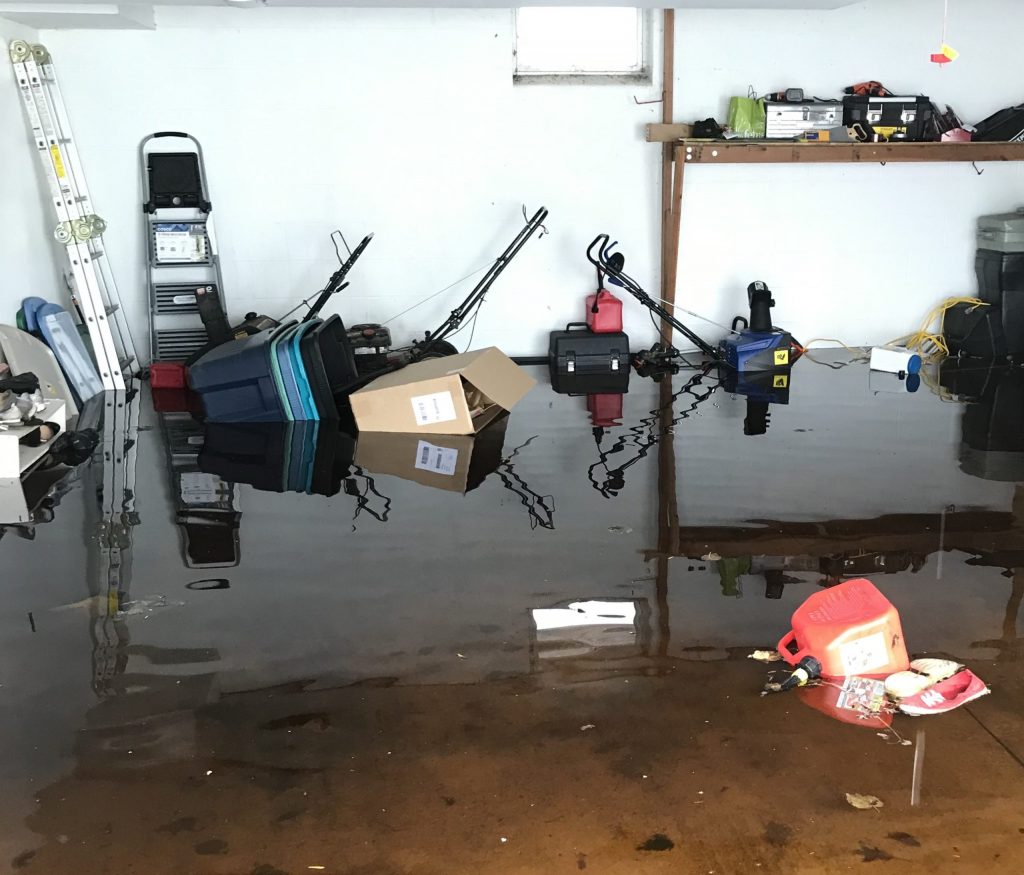 flooding in a garage has cause damage to a home and contents