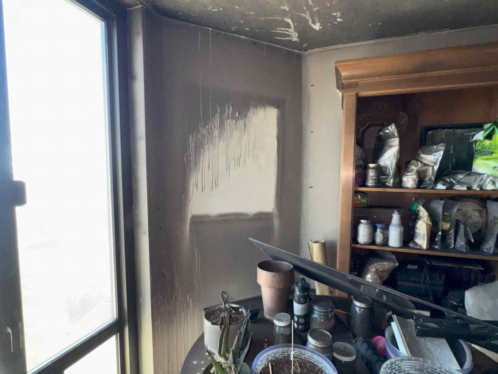 soot damage from a fire in a nearby room in the same house