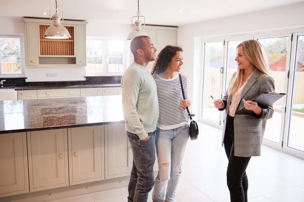 home buyers consulting thier real estate agent before purchasing a home on long island. Buyer Beware: What You Need to Know About Buying a House With Mold