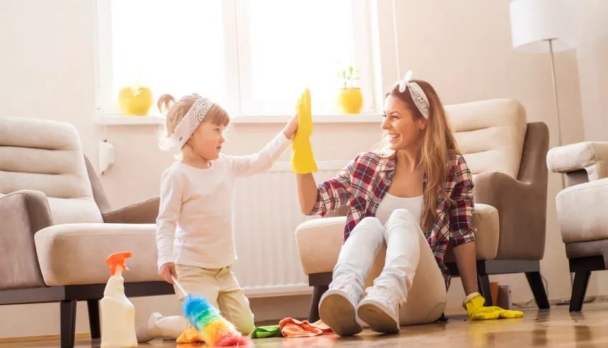 Parent and child giving a high five to one another after spring cleaning in their long island home