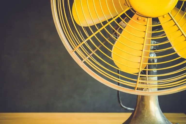 yellow fan that helps home owners stay cool in the summer heat
