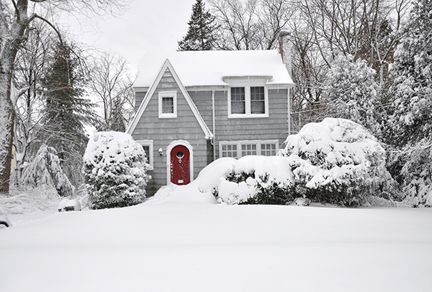 Long Island home in winter with ice dams and snow on the roof | PuroClean of Huntington