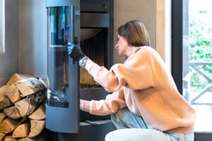 woman cleaning fireplace in her long island home