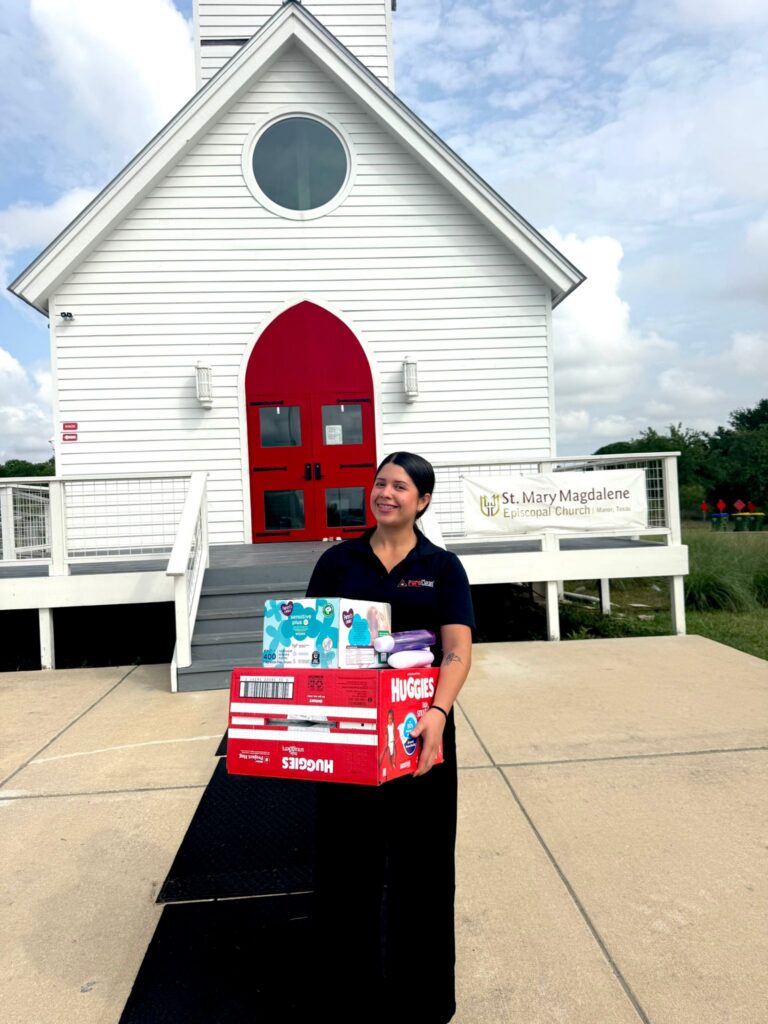 Volunteers handing out diapers and toys to moms during the Community Baby Shower in Manor, TX
