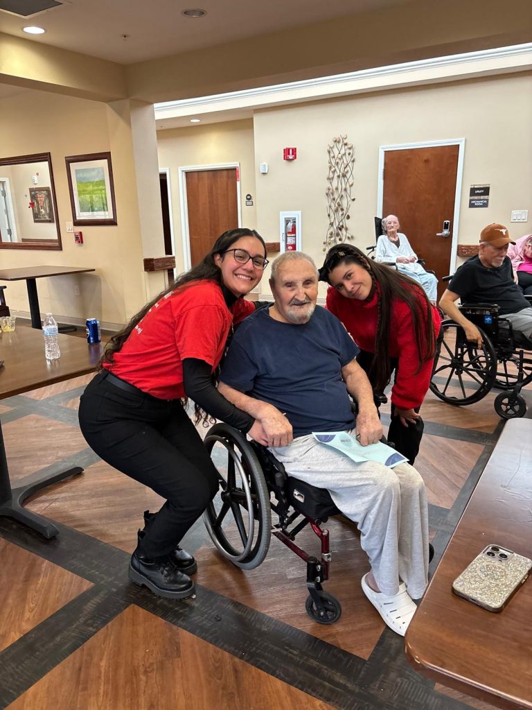 PuroClean staff singing karaoke with seniors at a local community center