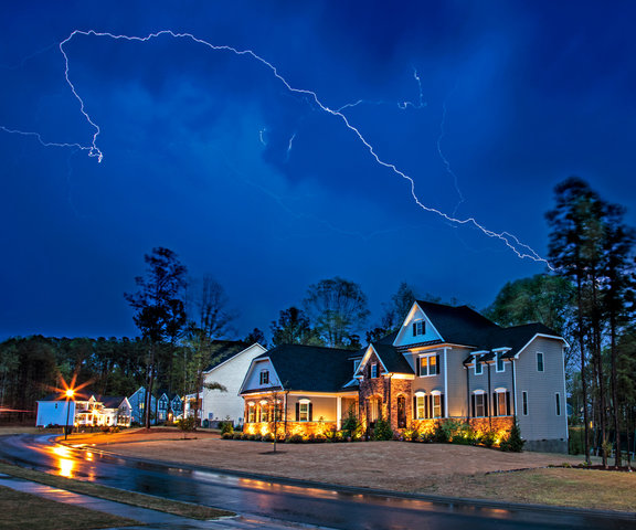 A lightning strike from severe thunderstorms in a residential area.
