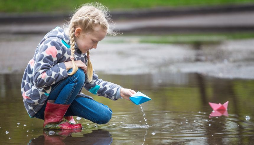 summer rain water damage - a child playing with rainwater