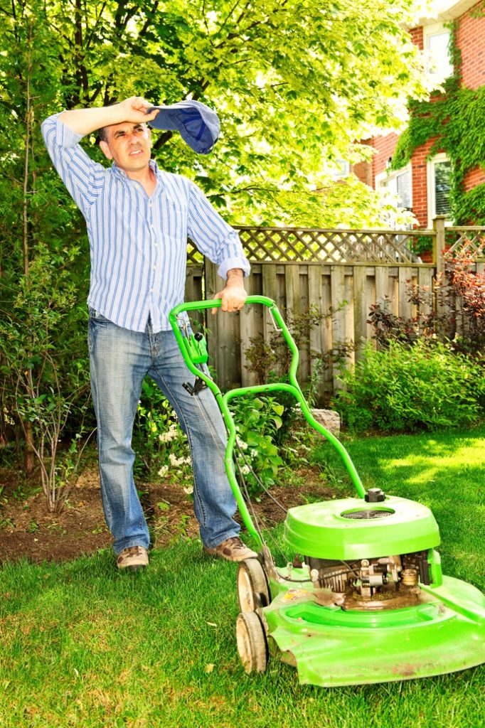 man mowing lawn in the heat - Hot Weather Safety Tips