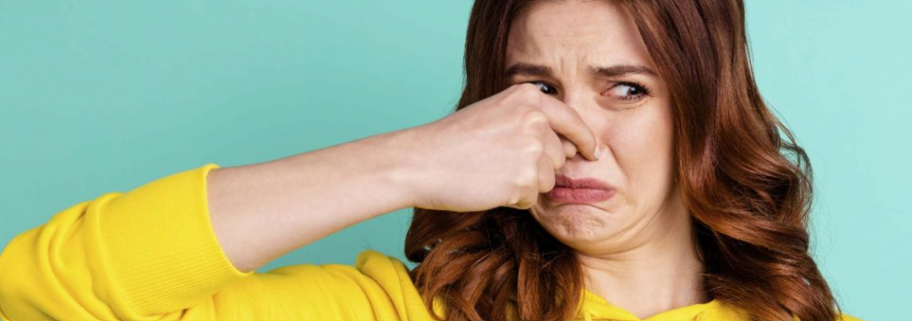 Women holding her nose due to a bad smell