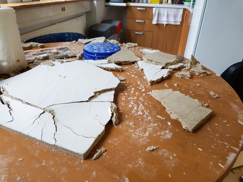 Ruined kitchen by collapsed ceiling. Severe water damage.