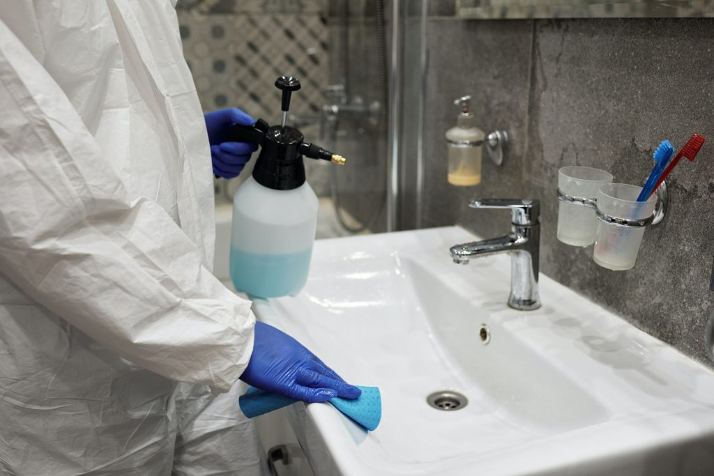 mold expert cleaning a sink