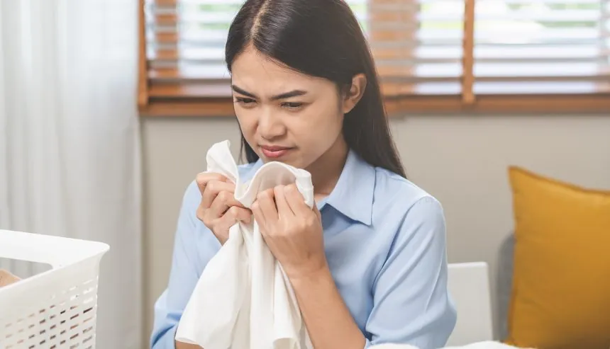 A woman sniffing clothes