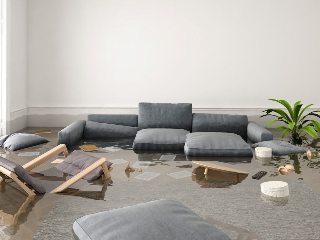 couch and chairs in flooded living room. PuroClean can help with Flood Restoration